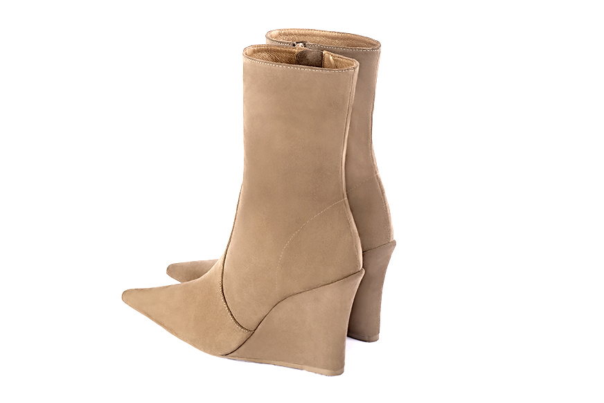 Tan beige women's ankle boots with a zip on the inside. Pointed toe. Very high wedge heels. Rear view - Florence KOOIJMAN